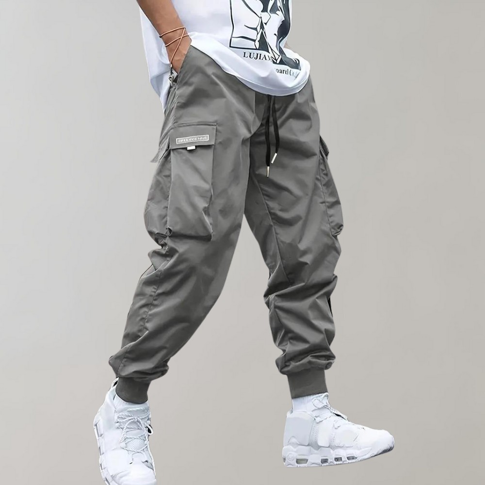 Tomáš – Muške Cargo Jogging Hlače – Ljubičaste Streetwear Hlače s Džepovima na Zip i Riblji Rep